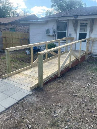 Custom wooden wheelchair ramp added to San Angelo TX  residential entryway.